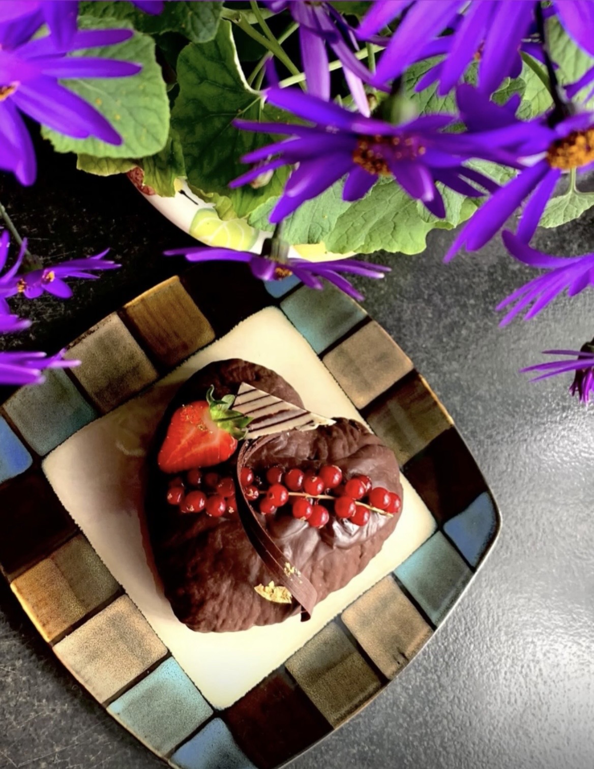 Heart-shaped chocolate cake with berries